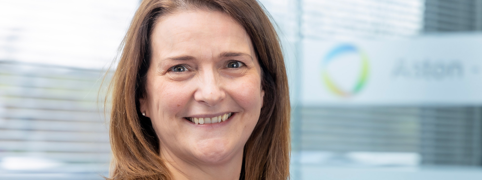 Woman smiling at camera in bright office