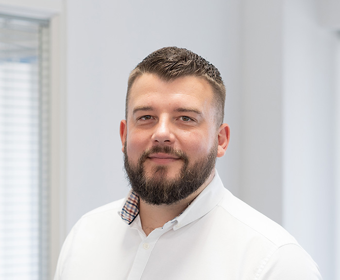 man smiling at camera in white shirt