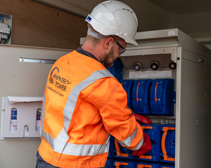 Man in Maintech hi-vis working on electrics